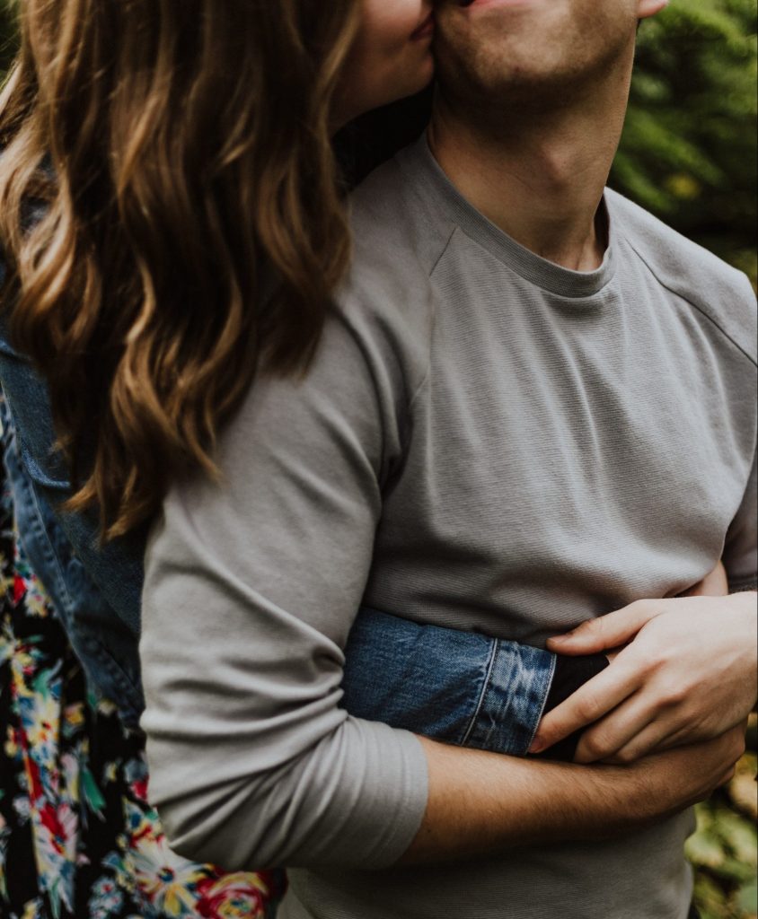 a woman hugging a man from behind