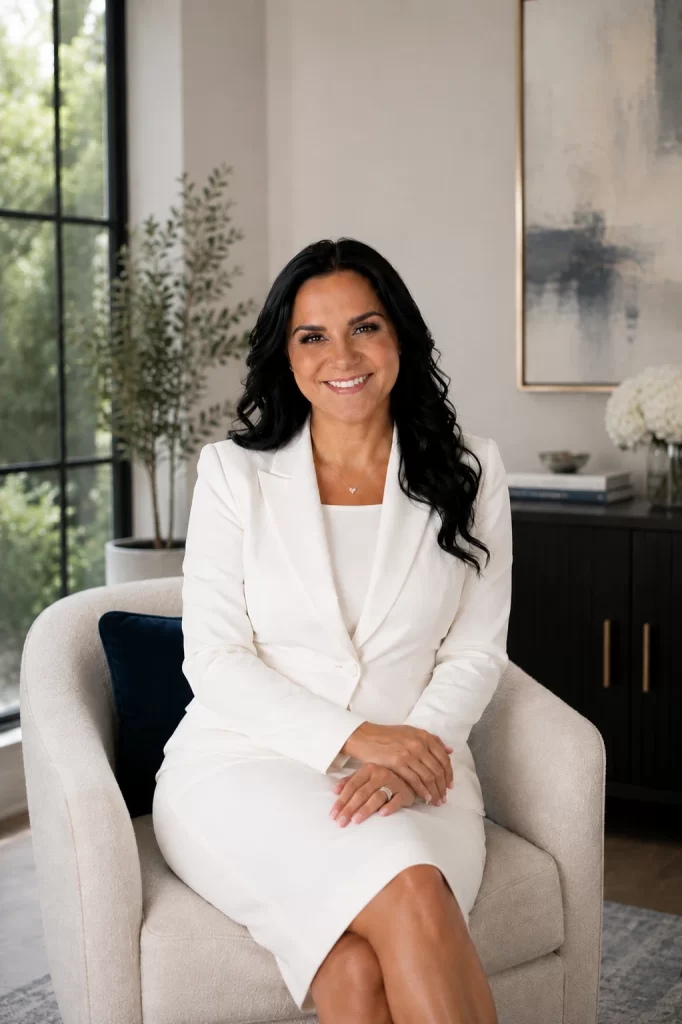 Janessa Borges, LCSW, seated in a white suit
