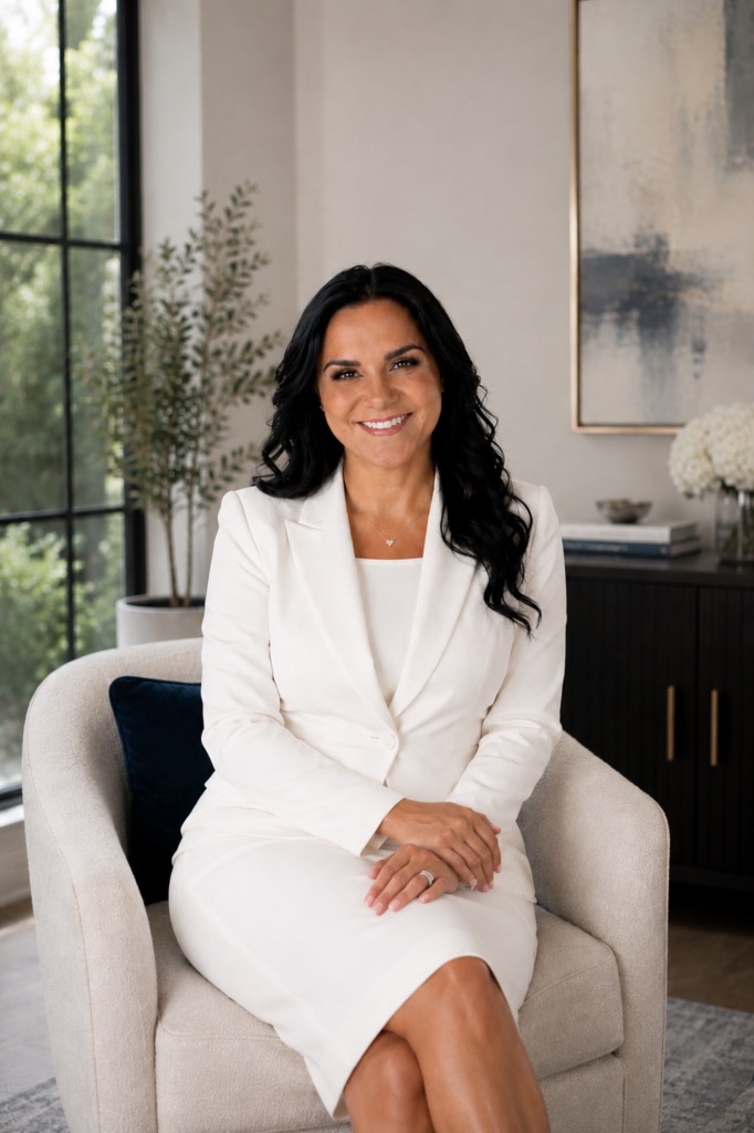 Janessa Borges, LCSW, seated in a white suit